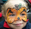 Girl with pumpkin face-paint at Halloween